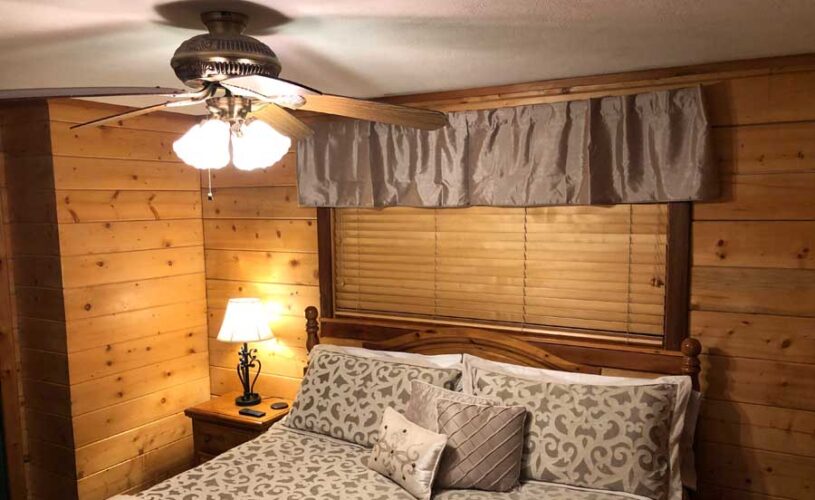 shady oak cabin bedroom with king bed