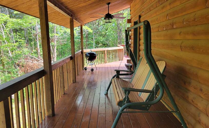 whispering pines cabin deck with swing in eureka springs